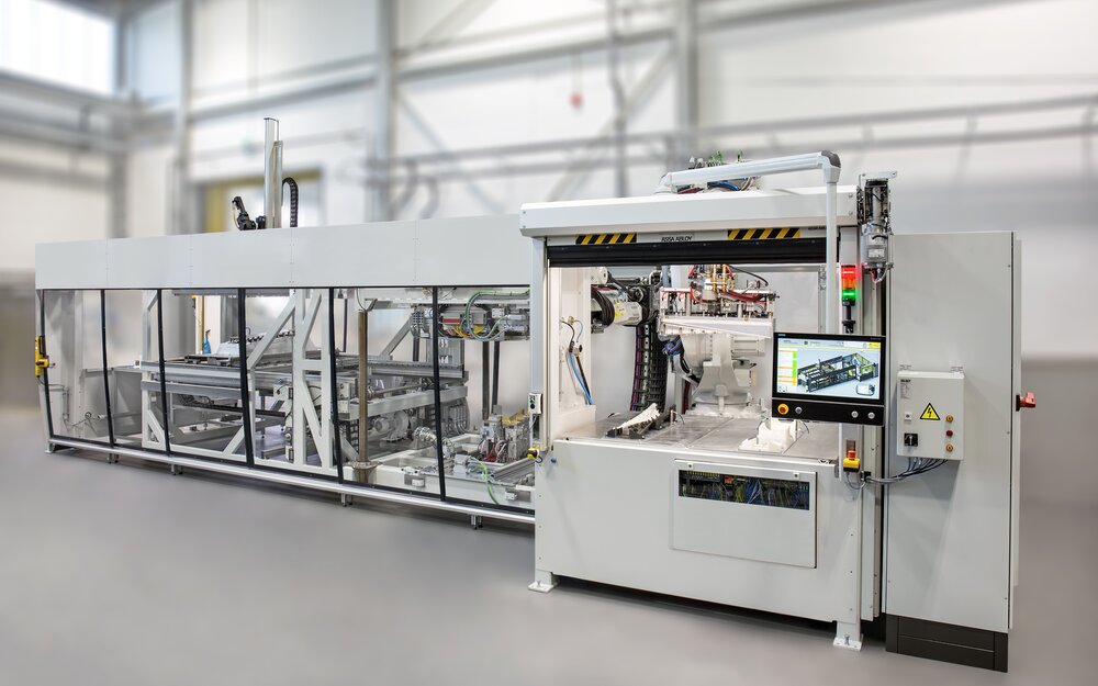 The new highly automated modular Kiefel vacuum lamination system utilizing the TBL process (Tailored-Blank-Laminating). The new highly automated modular Kiefel vacuum lamination system utilizing the TBL process (Tailored-Blank-Laminating).