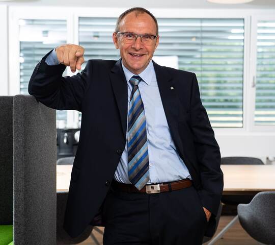 Philipp Riedl standing in his office