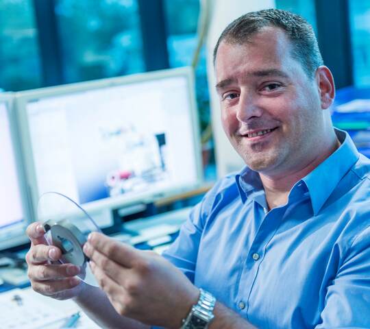 Man showing machine parts