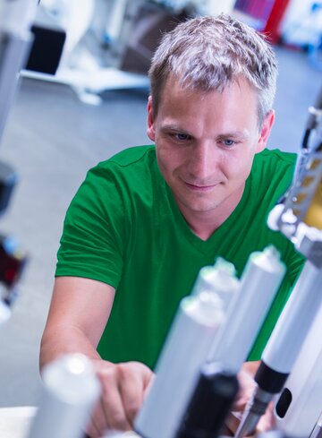 Man working on tube machine
