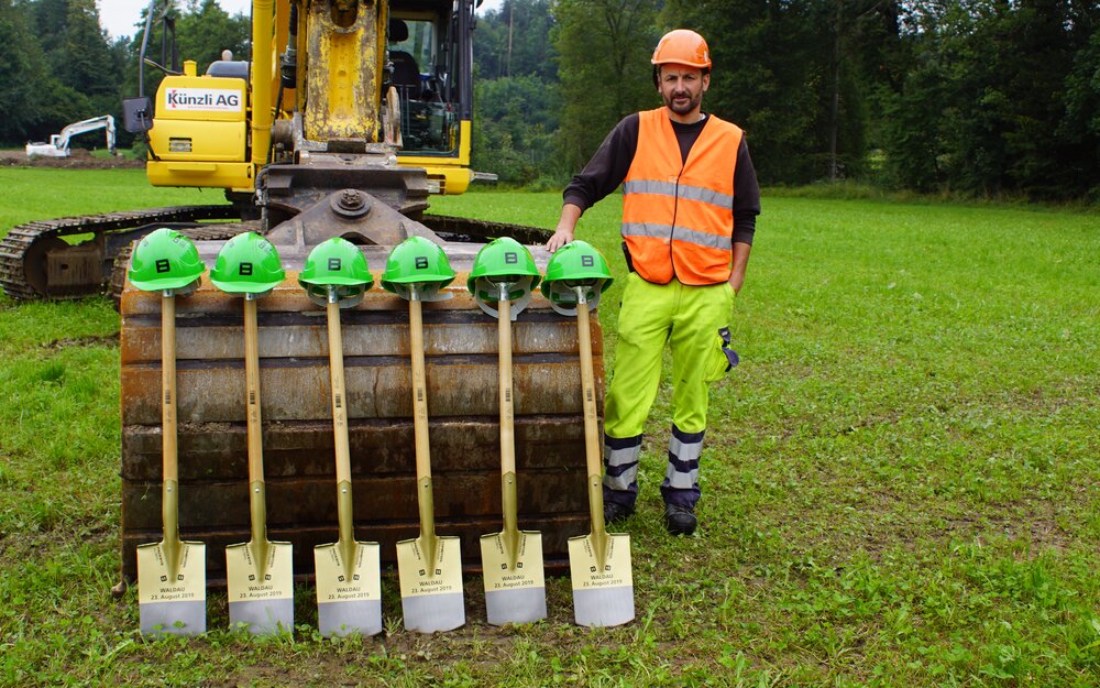 shovel and helmets in front of excavator