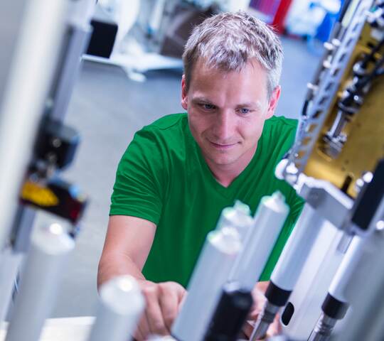 Man working on tube machine