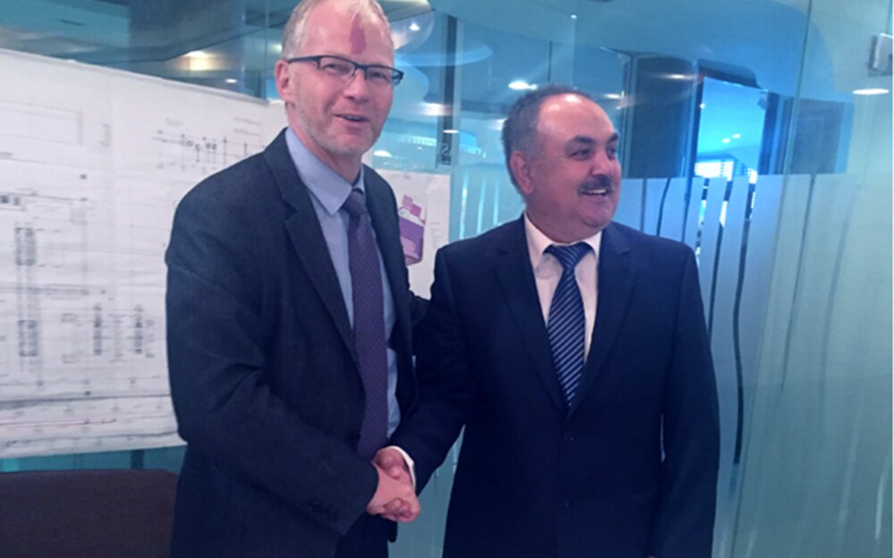 Aydan Faik and Helmut Huber shaking hands on a prosperous future
