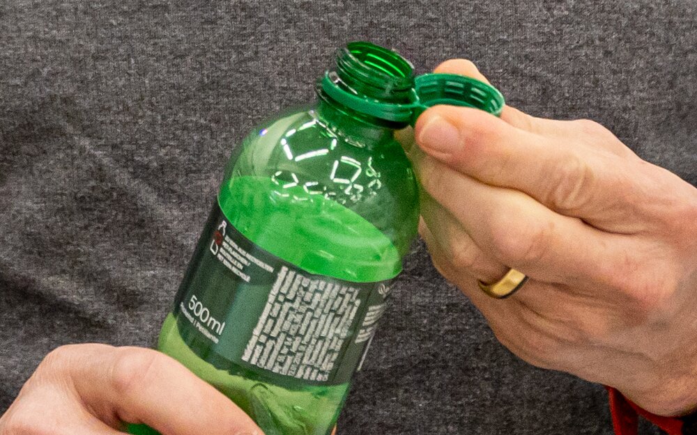 water bottle with tethered closure