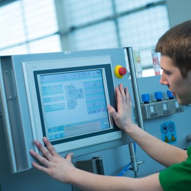 Man touching machine panel