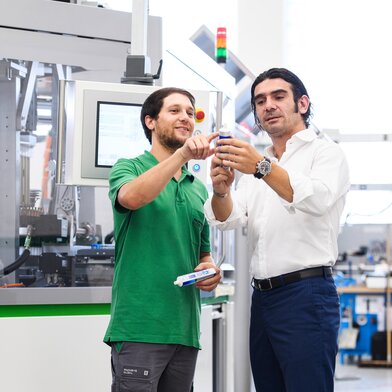 Sales manager inspecting PackSys Global tube