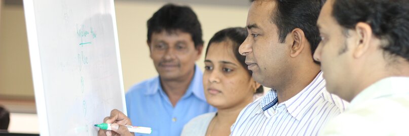 Employees working on flip chart