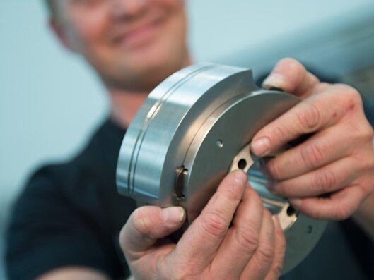 Man holding tube machine size parts