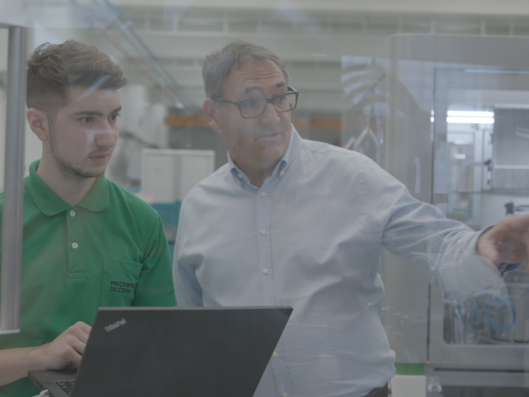 Two man looking at tube machine