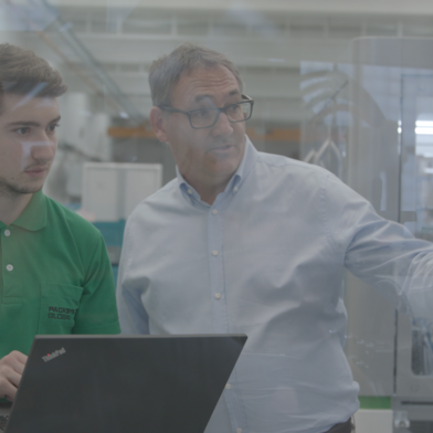Two man looking at tube machine