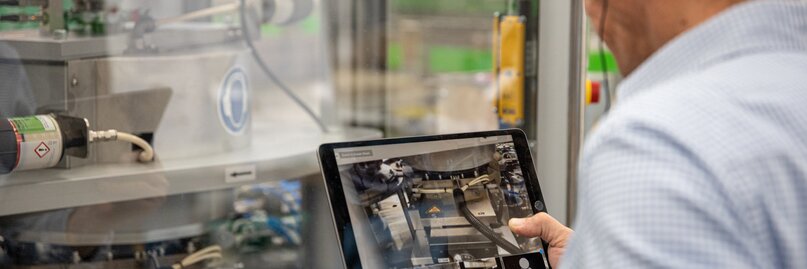 Man scanning a machine with tablet